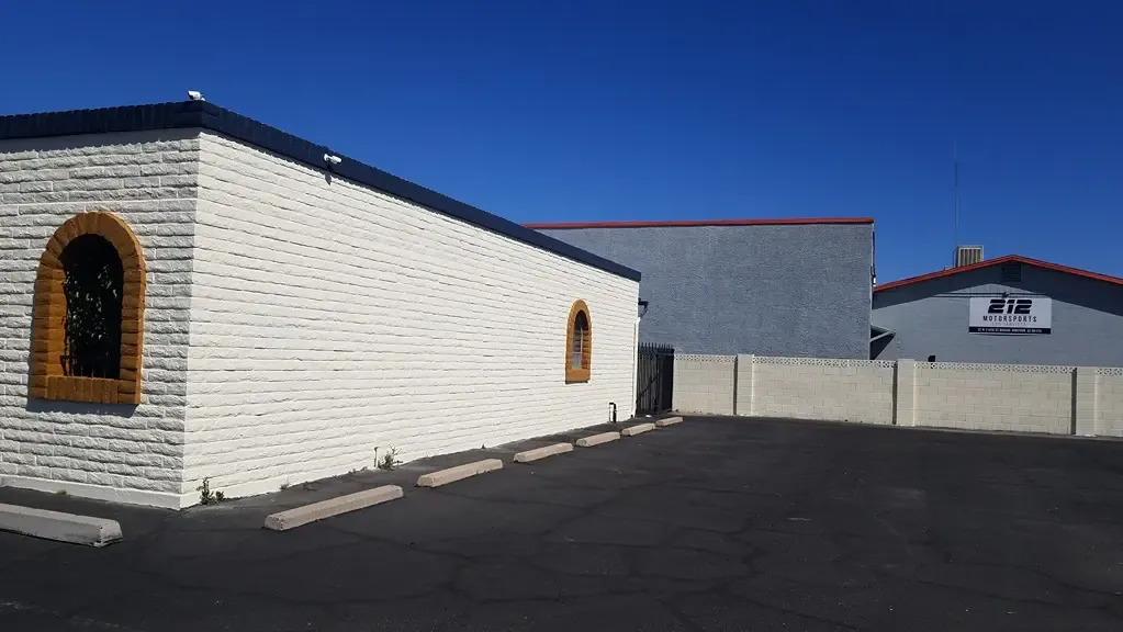 open vehicle parking next to a storage facility welcome center