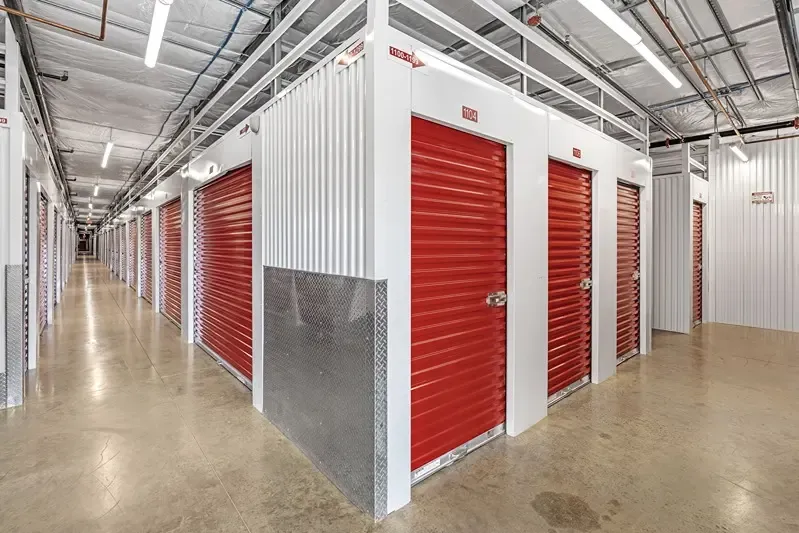 hallway with red indoor storage units