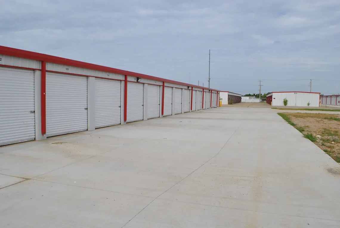 Paved road with outdoor storage units.