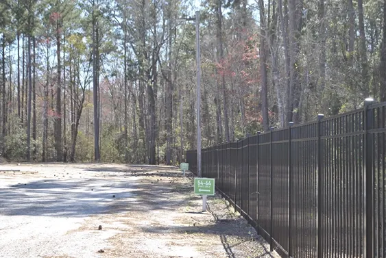Gated facility near forest.