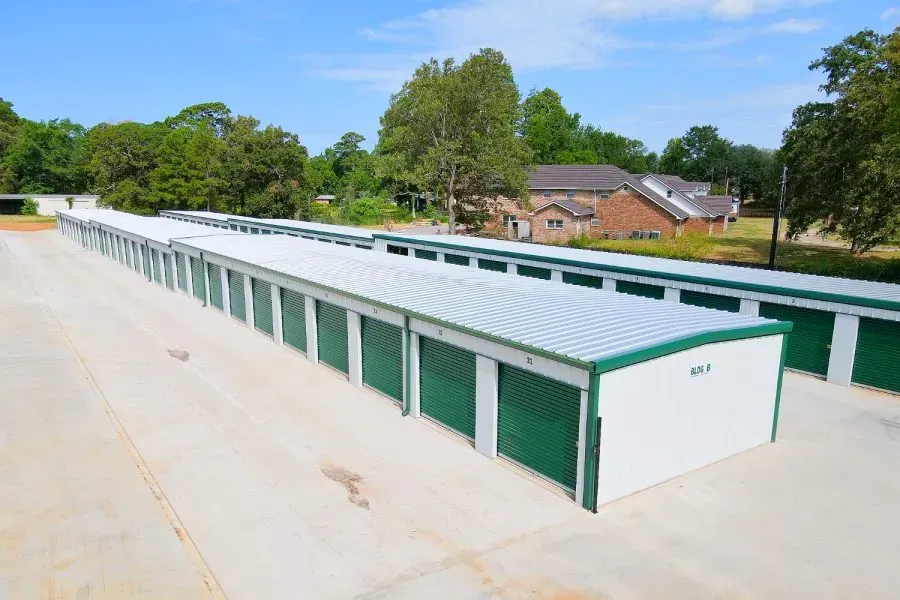 Storage facility exterior with green rollup doors