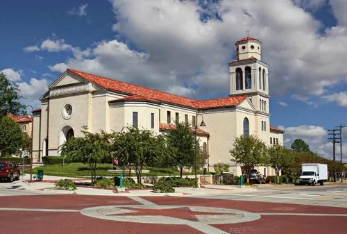 Church building with red-tiled roof on a street corner in Longview, Texas