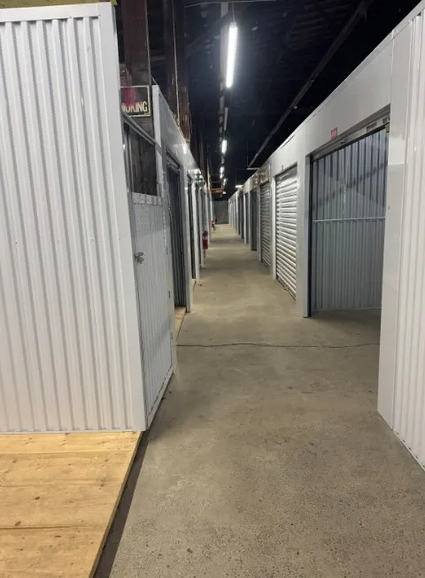 Row of indoor storage units with fire extinguishers.
