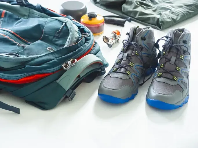 Hiking gear organized on the floor