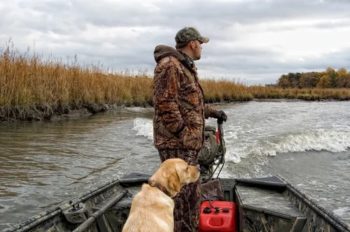 Hunter with outfitting gear on a boat.
