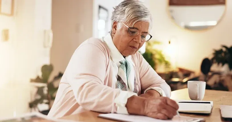 Older woman writing a list
