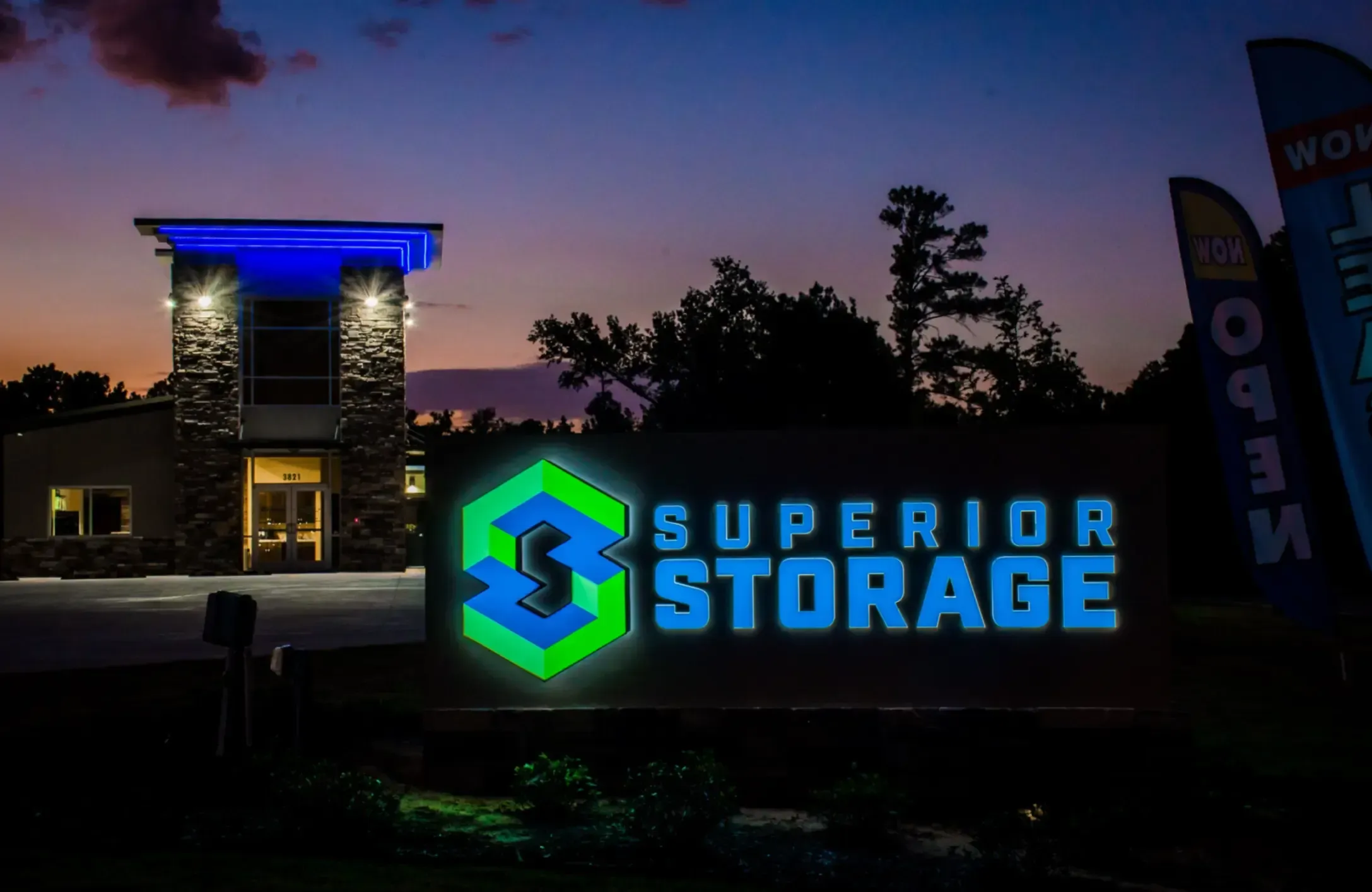 superior storage signage lit up and facility in back