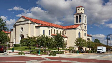 Church building with red-tiled roof on a street corner in Longview, Texas