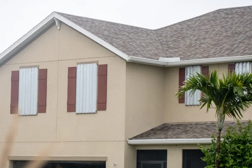 House with covered windows in preparation for storm